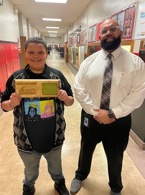 Domenic posing with his plaque and Coordinator of DEI Ken Nickson Jr.